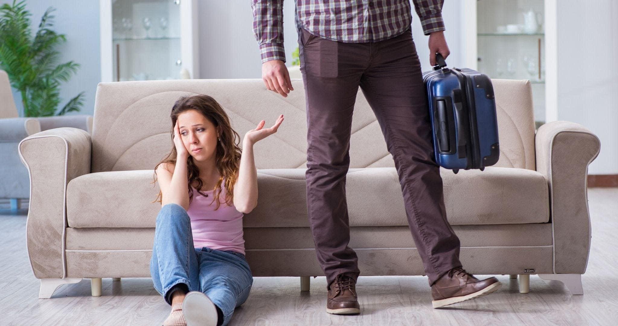 A person leaving their significant other carrying suitcase