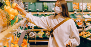 Woman wearing a mask shopping for produce