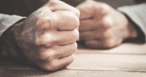 Angry fists on a table