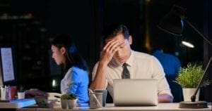 Two people working in office late at night