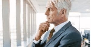 A man looking out the window thinking