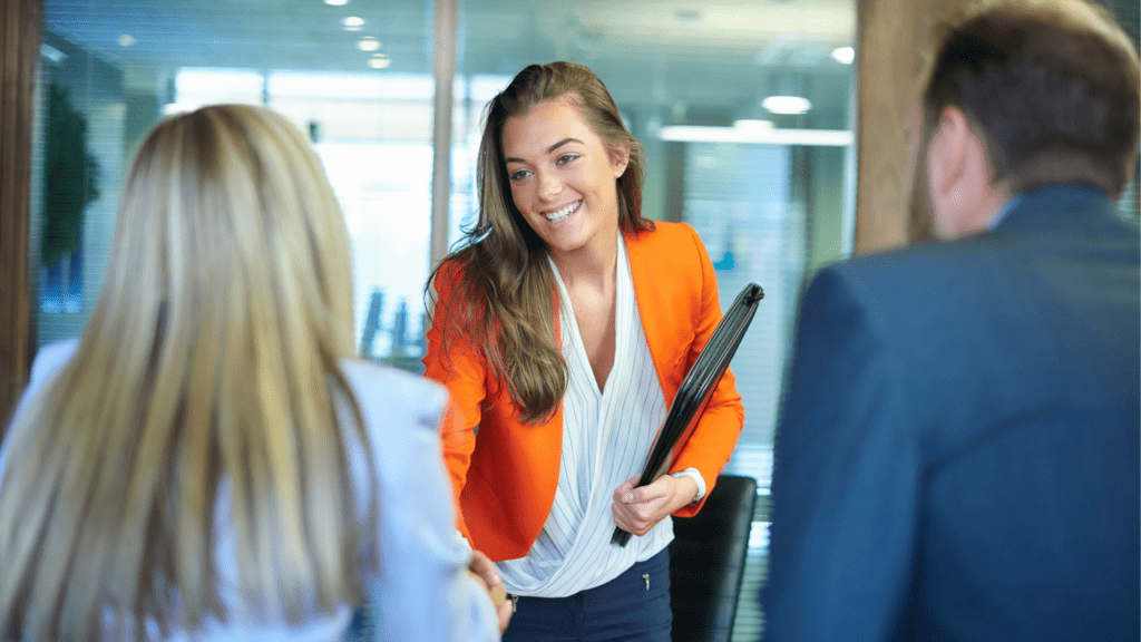 a woman being greeted by a man and a woman in an office using Key Tips for Positive Encounters and first impression