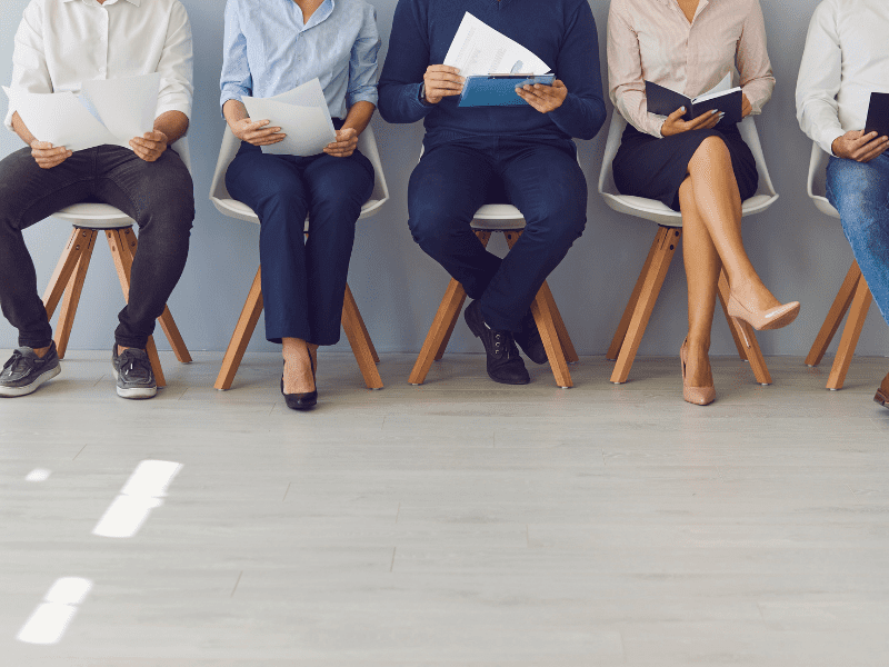 Applicants seated for job interviews, capturing the anticipation and readiness in the process to get an interview.