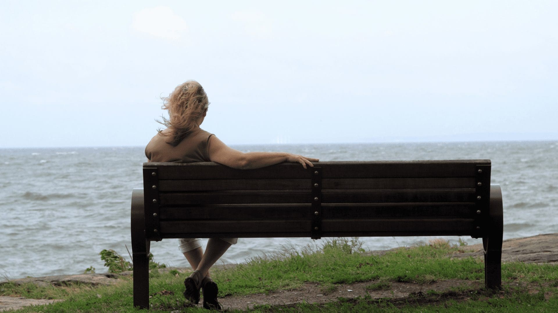 The woman in the image is sitting alone on a bench in a park, suggesting she may be experiencing autophobia or the fear of being alone. However, through neuropsychology, the study of the relationship between the brain and behavior, she may be able to understand the underlying mechanisms of her phobia and develop strategies to overcome it. With the help of a therapist, she may learn how to manage her symptoms and gradually feel more comfortable being alone. Struggling with autophobia