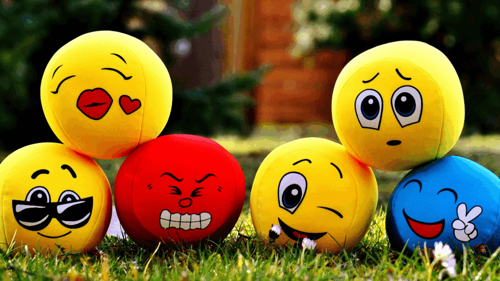 Colorful emoji balls showing different primary emotions like happiness, anger, and sadness.