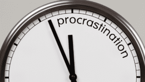 Clock pointing to 'procrastination', symbolizing overcoming procrastination through life coaching for achieving goals and behavior change. Neuroscience of Procrastination