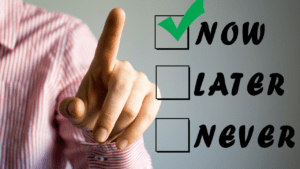 Man choosing 'now' over 'later' or 'never' on virtual screen, symbolizing overcoming procrastination through life coaching and achieving behavioral change.