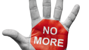 Hand displaying stop gesture with 'no more' text, symbolizing effective neuroscientific treatment and life coaching alleviating ocd symptoms.