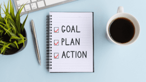 "Image: Notebook with 'Action, Plan, Goal' - Visual representation of life coaching techniques, goal setting in life coaching, and personal growth strategies for optimal development and empowerment."