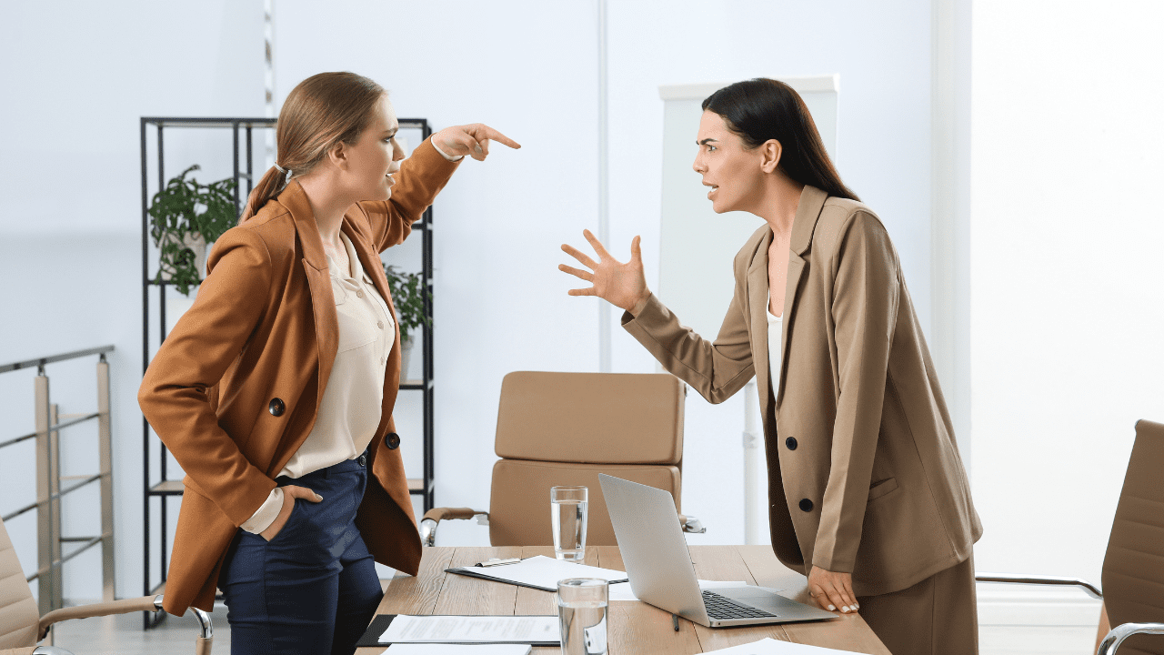 Two women in a heated argument demonstrating emotional reactivity, highlighting the need for neuroscience-based life coaching and brain-based coaching techniques to manage emotions.