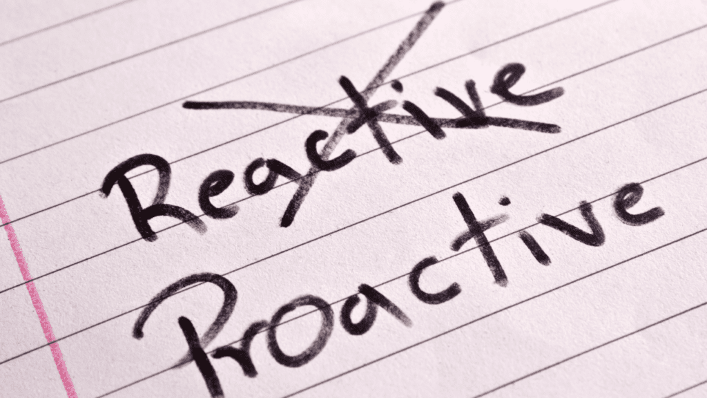 Piece of paper with the word 'reactive' crossed out and 'proactive' written below, symbolizing the transition from emotional reactivity to proactive control through neuroscience-based life coaching and brain-based coaching techniques.