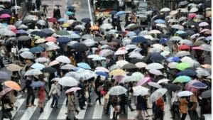 Crowd of people holding different color umbrellas, symbolizing various personality types.