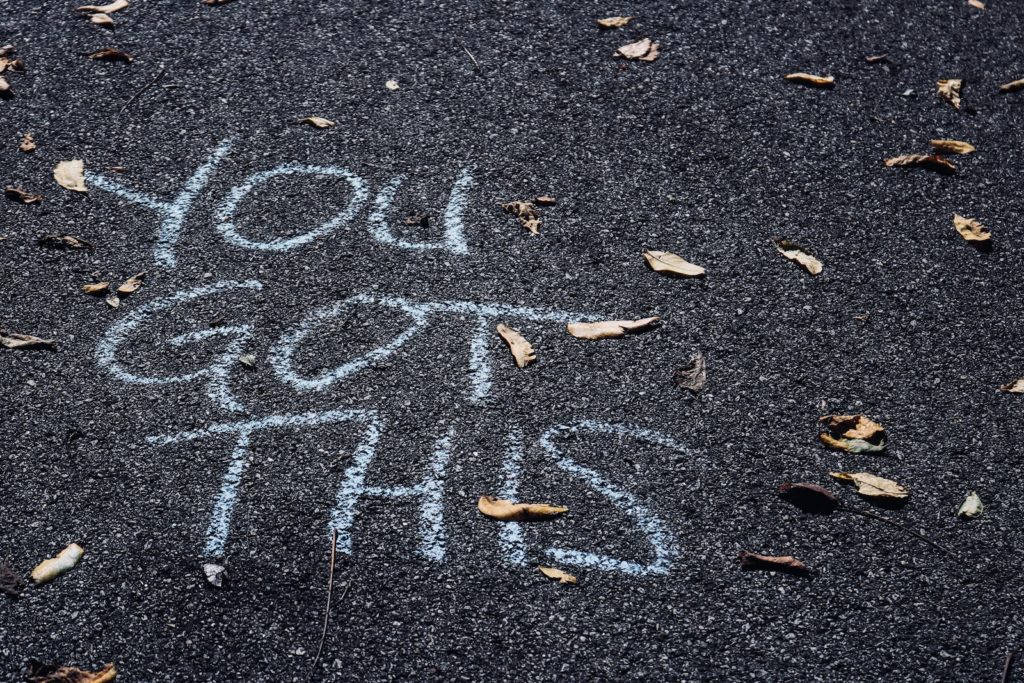 Chalk writing on asphalt saying "you got this," symbolizing overcoming borderline personality disorder and splitting