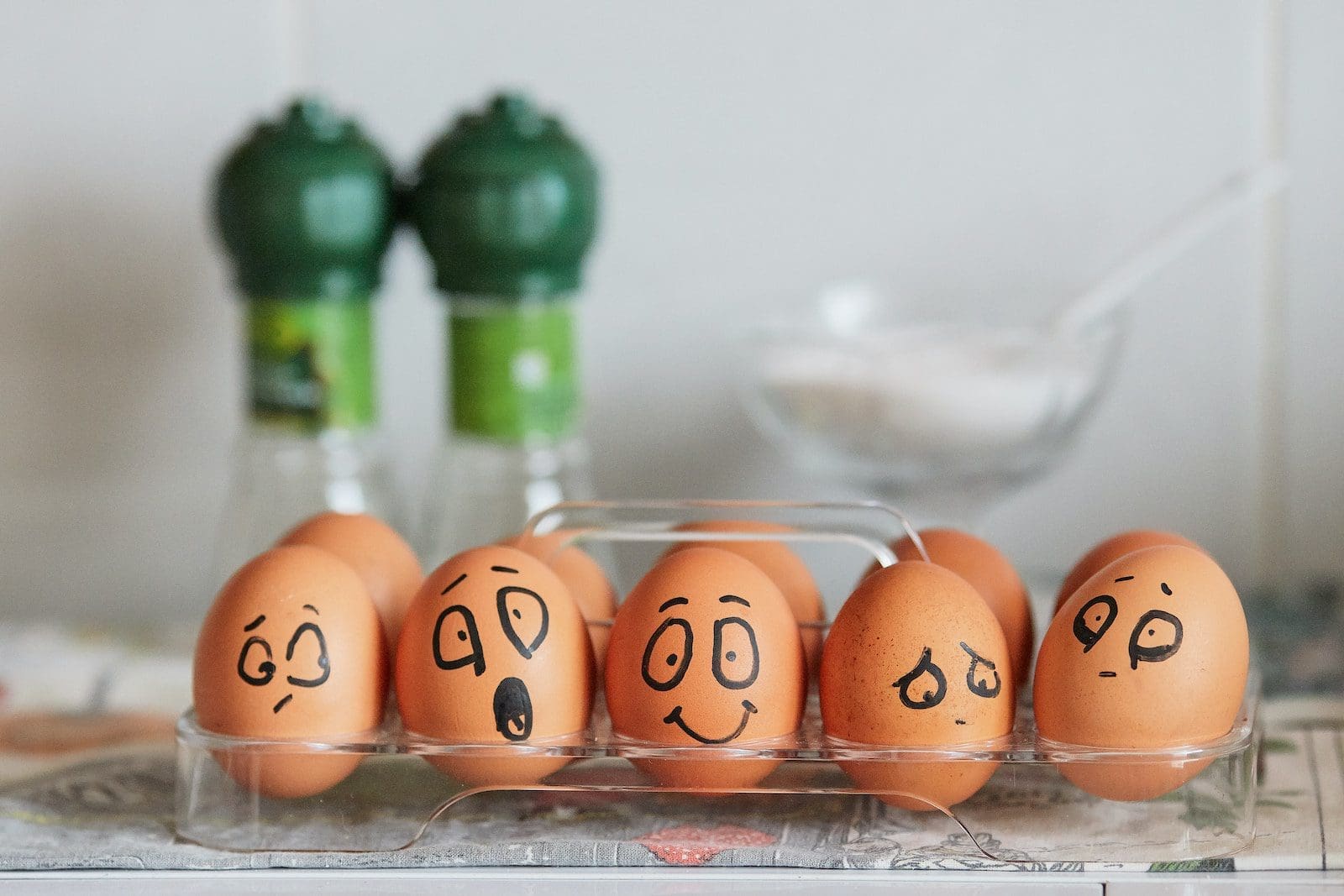 Carton of eggs with faces expressing various emotions, symbolizing the pillars of emotional intelligence.