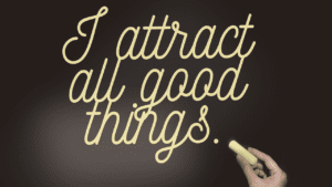 Blackboard with the words 'I Attract All Things Good', symbolizing the law of attraction and manifestation and thinking positive.