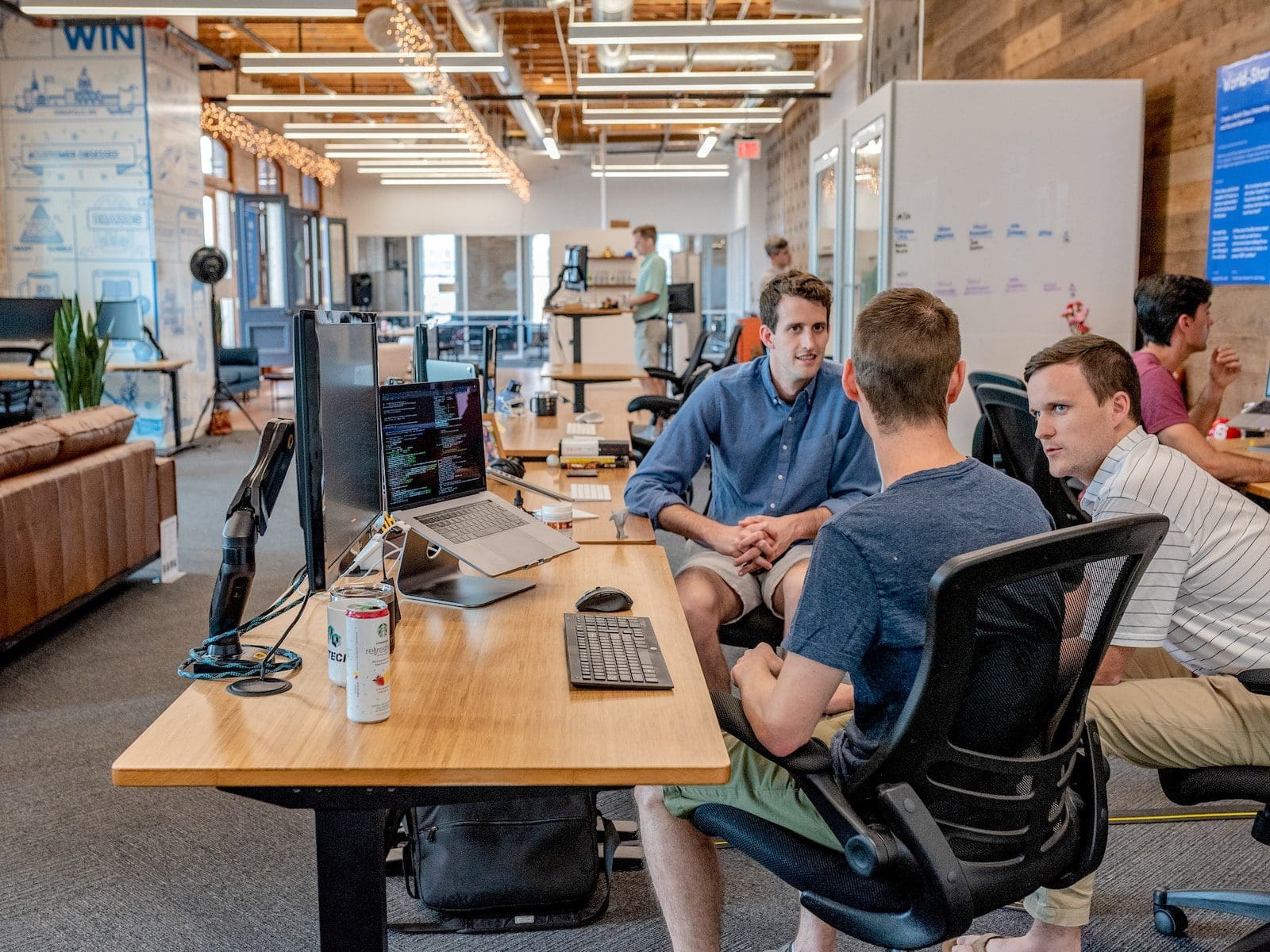 three men with one being assertive in explaining a work project, Impact of Assertiveness