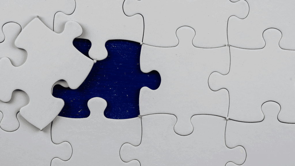 Exploring Brain Regions and Their Role in Cognitive Biases 2 Close-up of a puzzle with one missing piece, symbolizing the link between brain regions and cognitive biases.