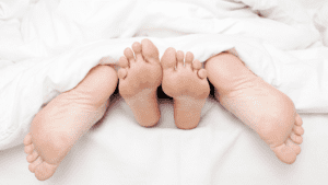 Couple's feet outside covers symbolizing brain chemicals during sex