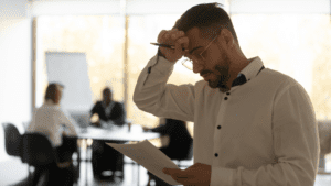 Man showing signs of stress due to fear of public speaking before a presentation.