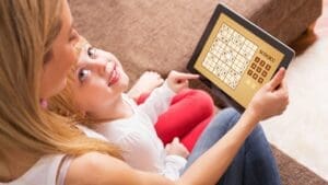 Mother and child playing Sudoku to boost neuroplasticity