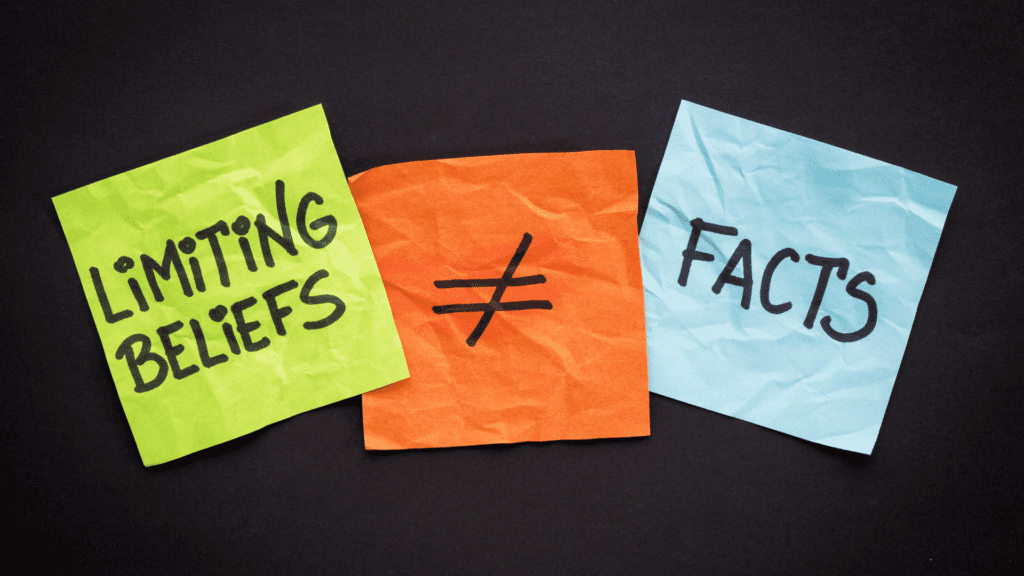 Three colorful sticky notes with the words "Limiting Beliefs ≠ Facts" written on them.