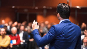 Man confidently giving a lecture, overcoming his fear of public speaking.