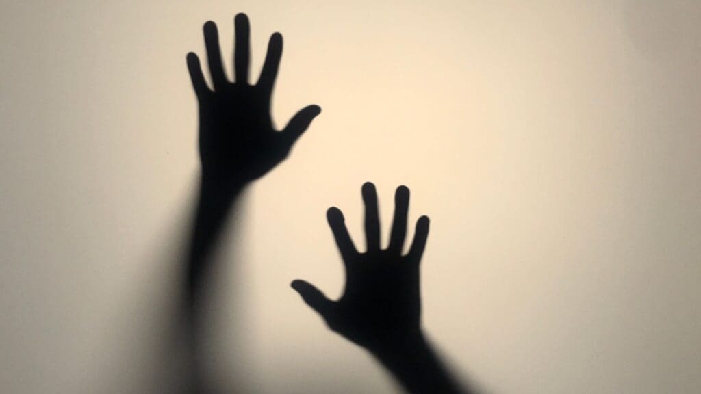 Silhouettes of two hands reaching upwards