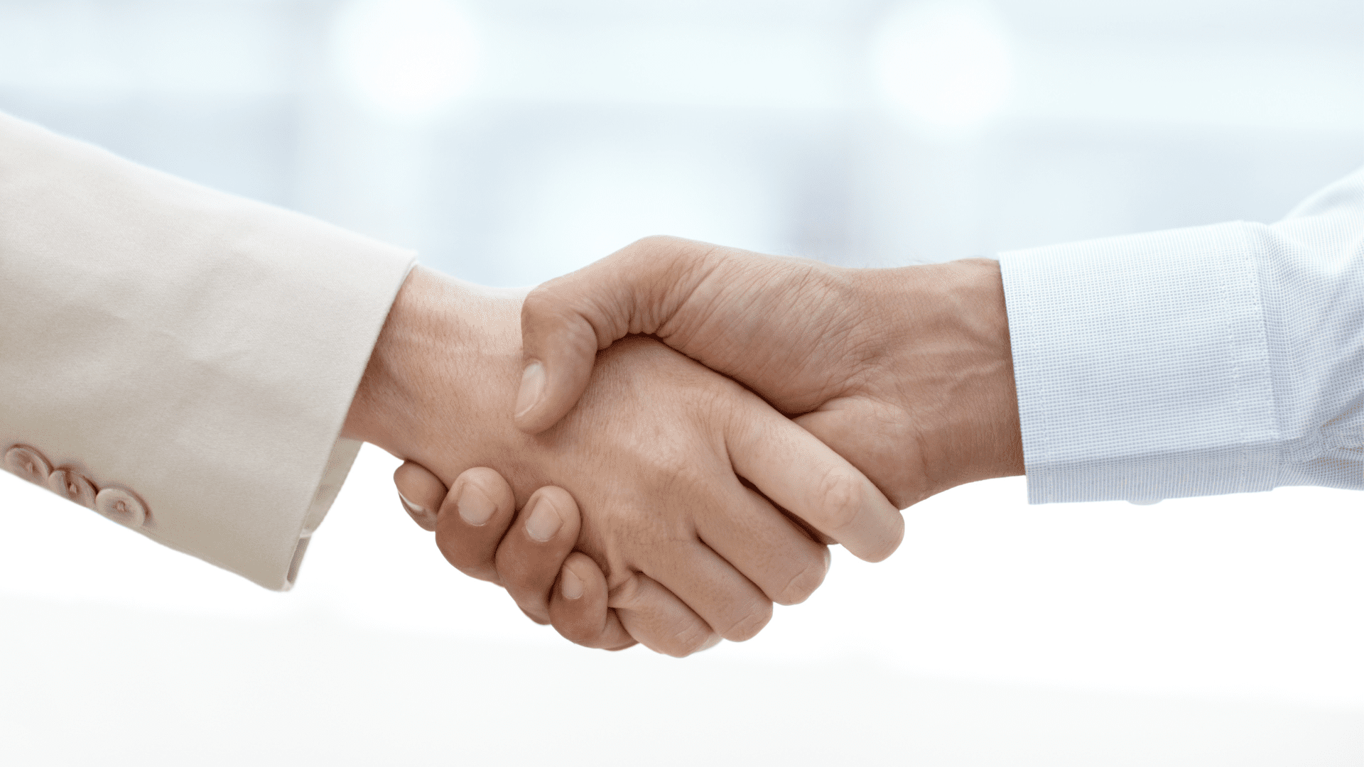 Close-up of a handshake, symbolizing building healthy relationships in a professional setting.