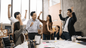 a group of people celebrating in a room after their deep work habits proved to be a great accomplishment