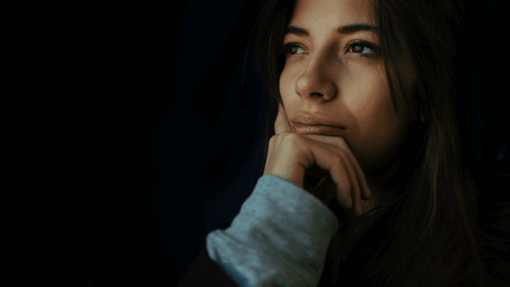 a woman with her hand on her chin