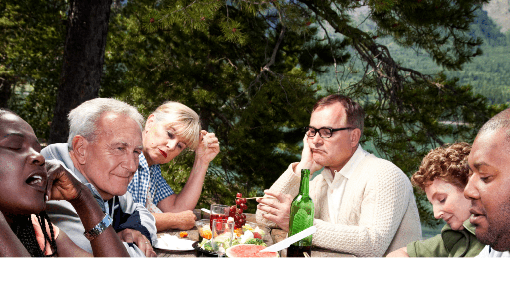 a group of people sitting at a table at a family gathering dealing with anxiety