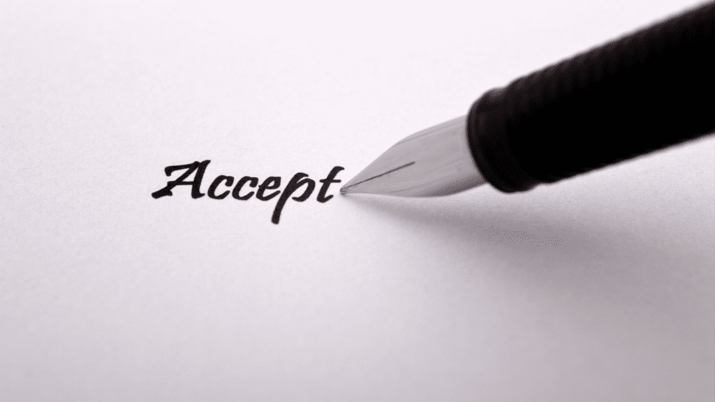 a pen writing on a piece of paper spelling the word accept indicating the power of radical acceptance.
