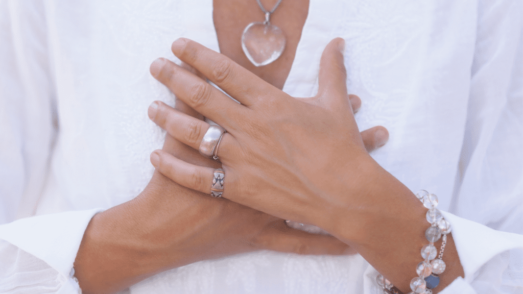 a close up of hands with rings and necklaces