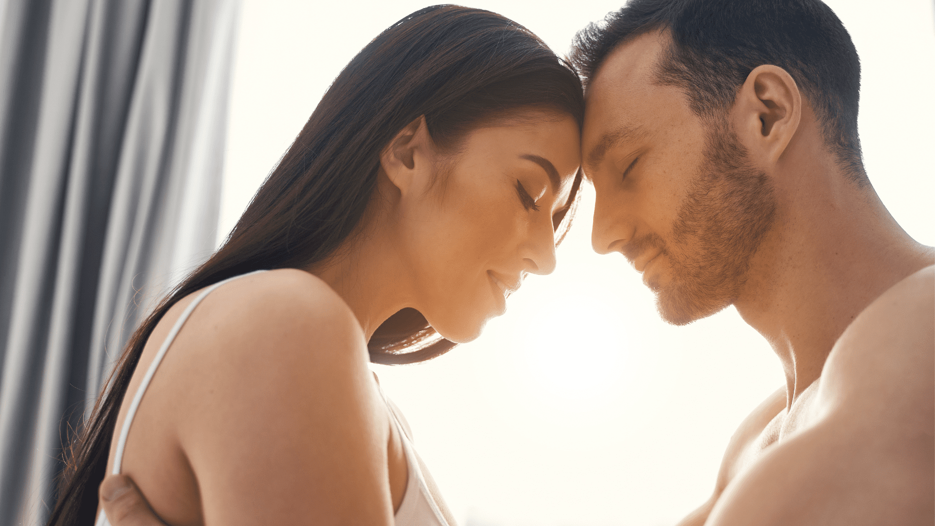 a man and woman touching their foreheads displaying vulnerability