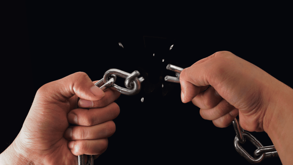 hands holding a chain with a broken link indicating why you cannot move on from a relationship