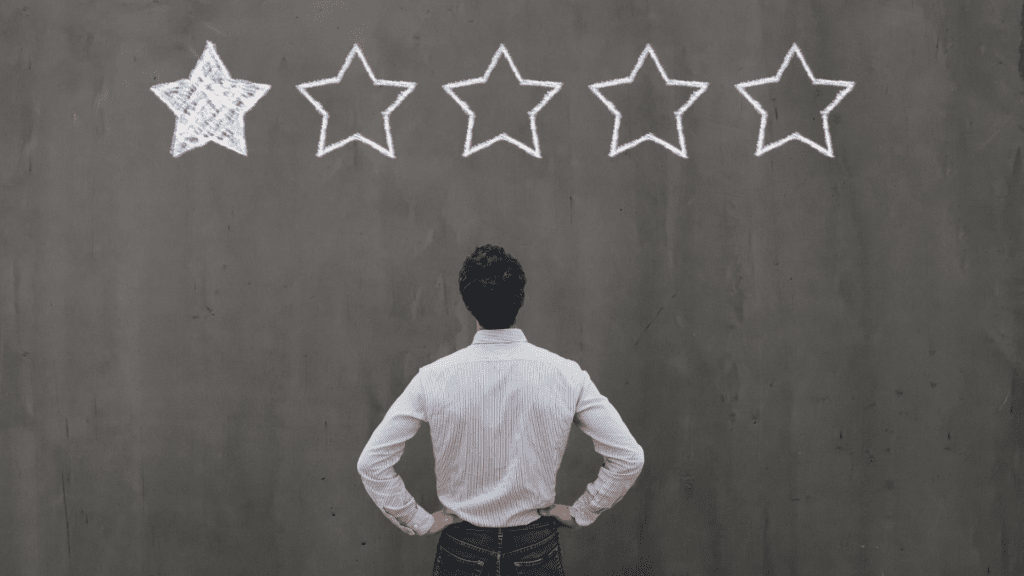 a man standing in front of a wall with stars drawn on it