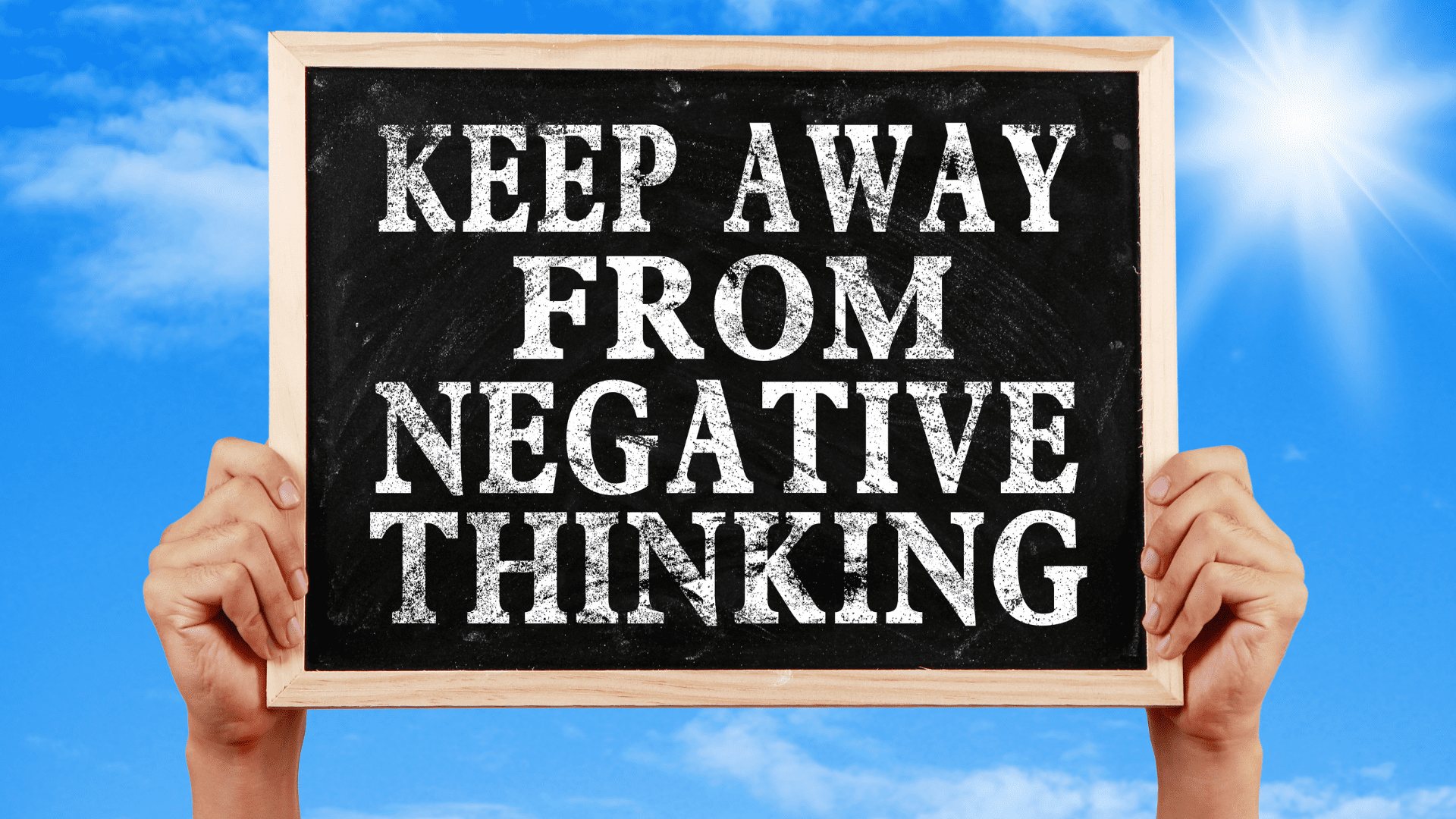 a blackboard with white text saying to keep away from negative thinking