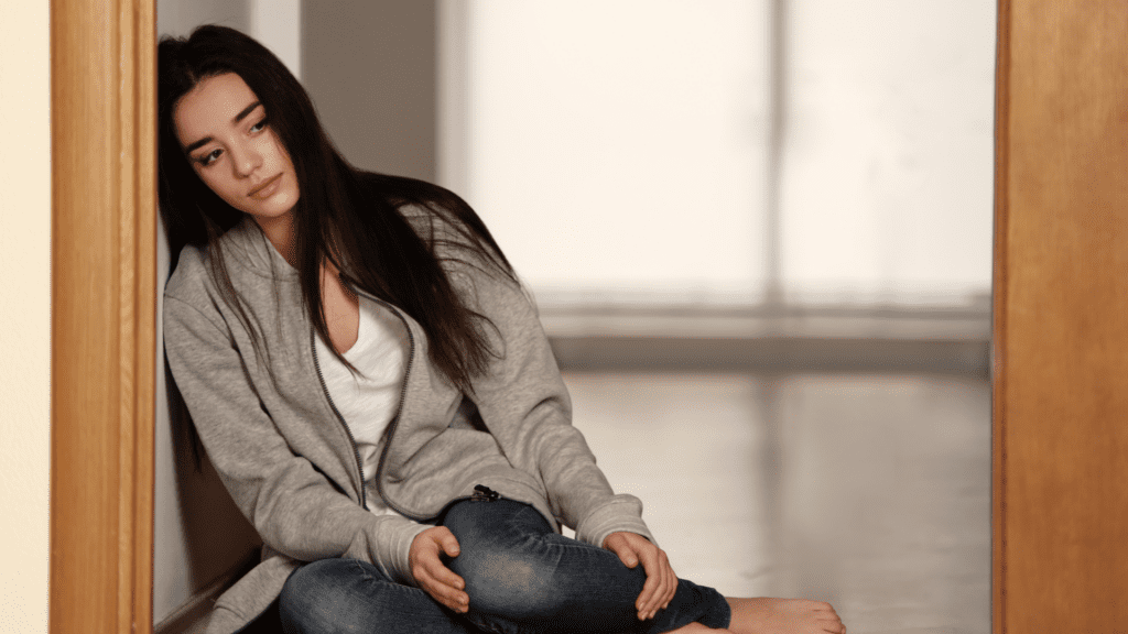 a woman sitting on the floor having difficulty in overcoming depression