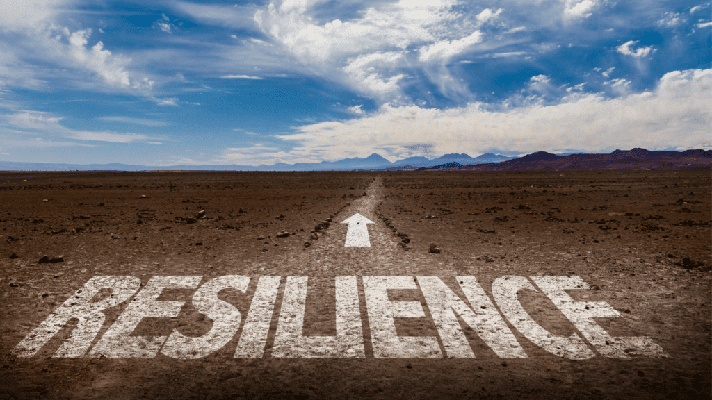 a road with text painted on it saying resilience