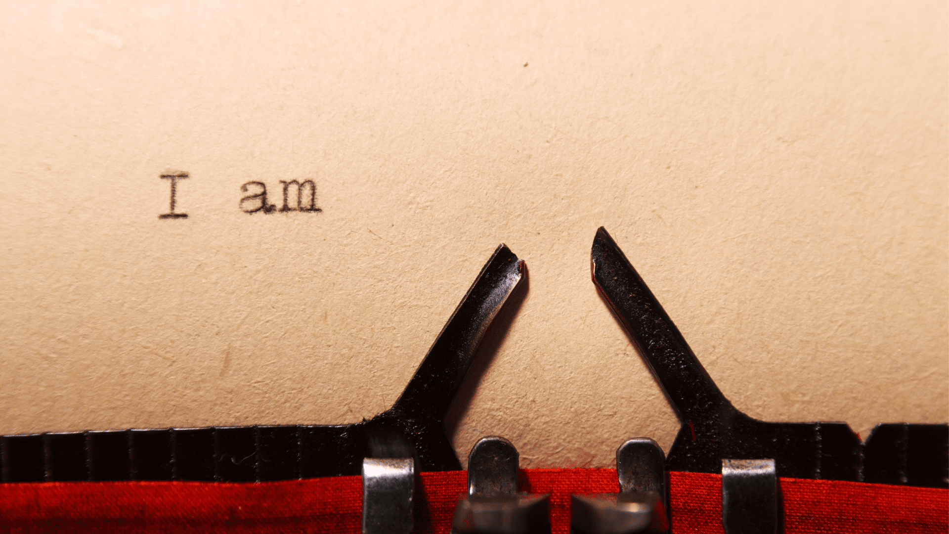 a typewriter with a red cloth and black text