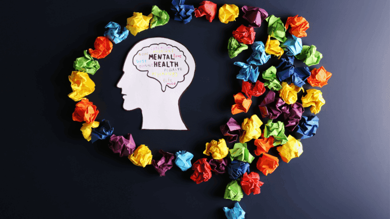 a paper with a head and a brain surrounded by colorful crumpled paper