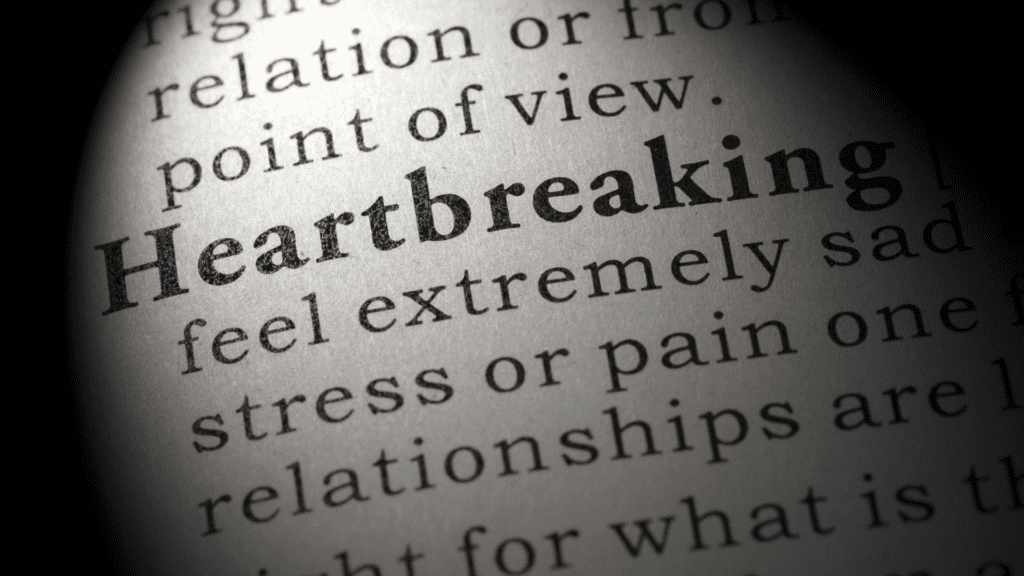 a magnified photo of the word heartbreaking about moving on after a break-up