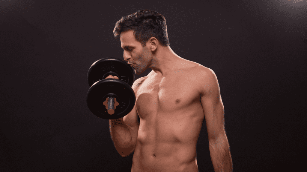 A man lifting weights who  is kissing the dumb bell proving he is a narcissist.