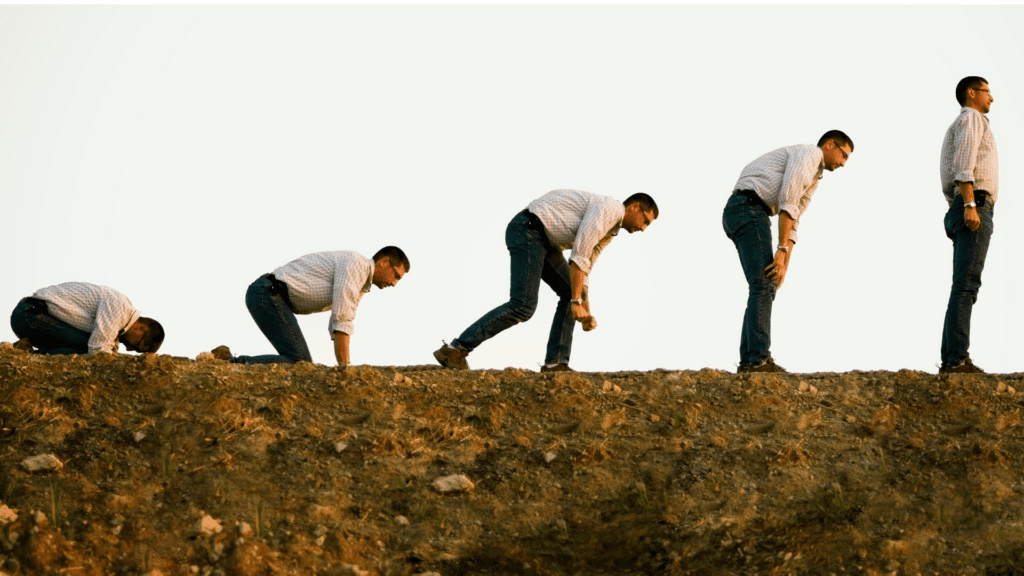 Sequence of a man standing up from a crouching position

