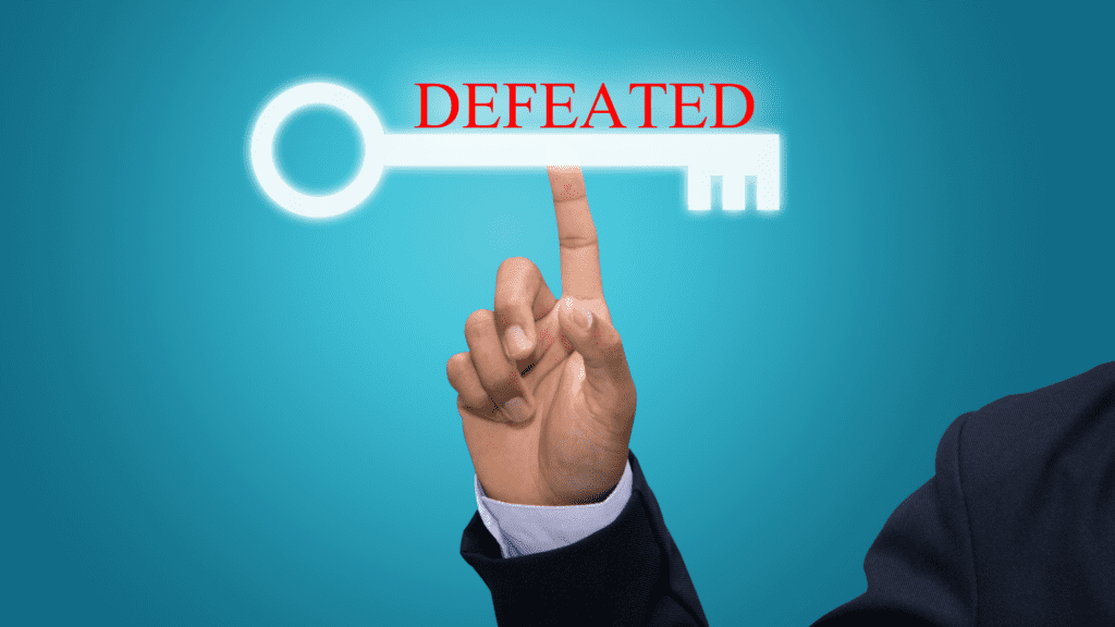 Concept of being defeated by self-defeating behaviors The image depicts a hand pointing to a large key, symbolizing the solution, with "DEFEATED" text above it, representing the problem of self-defeating behaviors holding people back. The image conveys the idea that identifying and addressing self-defeating behaviors is crucial for unlocking one's full potential.