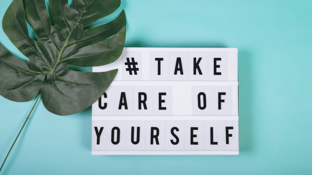 Take care of yourself message on a light box referring to mental well-being A lightbox with the message "# TAKE CARE OF YOURSELF" on a teal background with a green leaf, emphasizing the importance of self-care and mental well-being.
