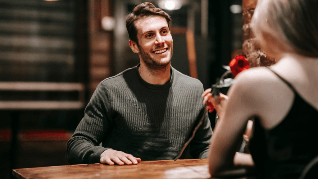 Man smiling on a date representing the neuroscience behind dating challenges.

