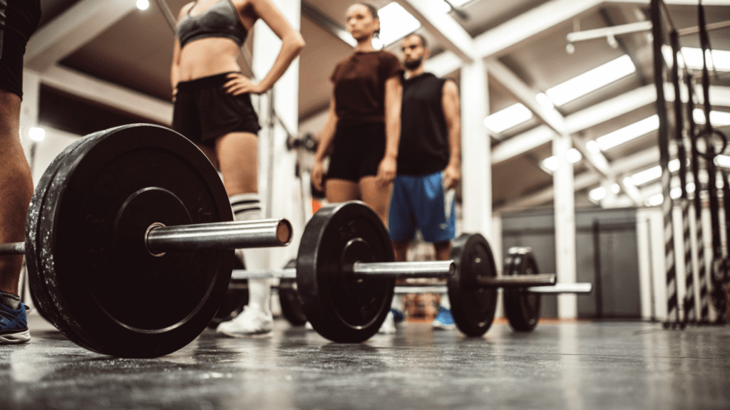 Individuals in a gym practicing discipline and self-control with weight training


