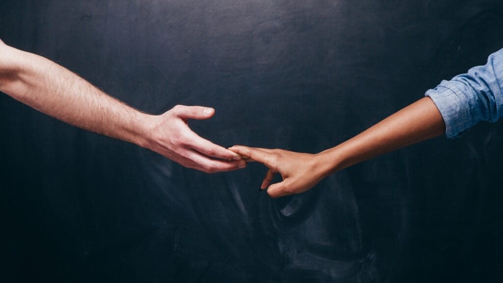 Two hands reaching out to touch, symbolizing connection and overcoming emotional distance.

This image of two hands reaching for each other symbolizes the emotional connection between partners. It represents the struggle to maintain closeness and intimacy in the face of overthinking, and the possibility of overcoming it to restore trust and harmony in the relationship.