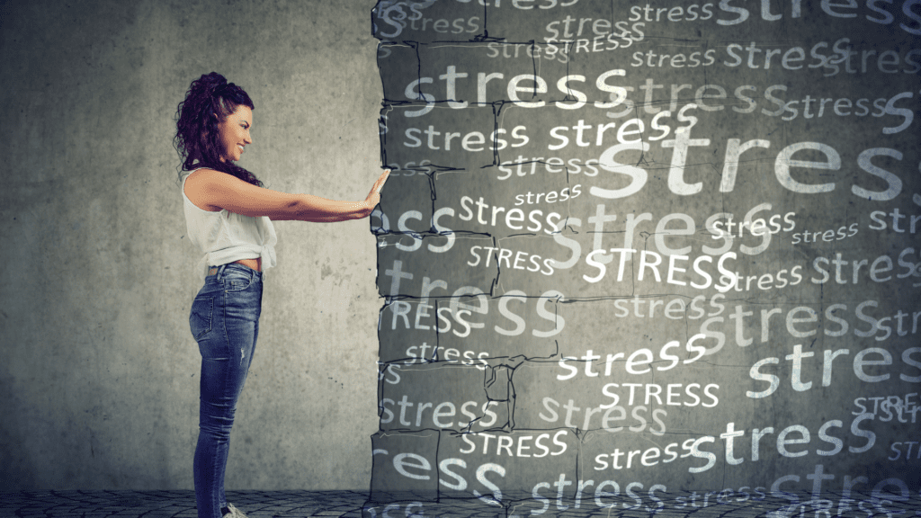 A woman pushing against a wall of stress, symbolizing emotional regulation and stress management.

